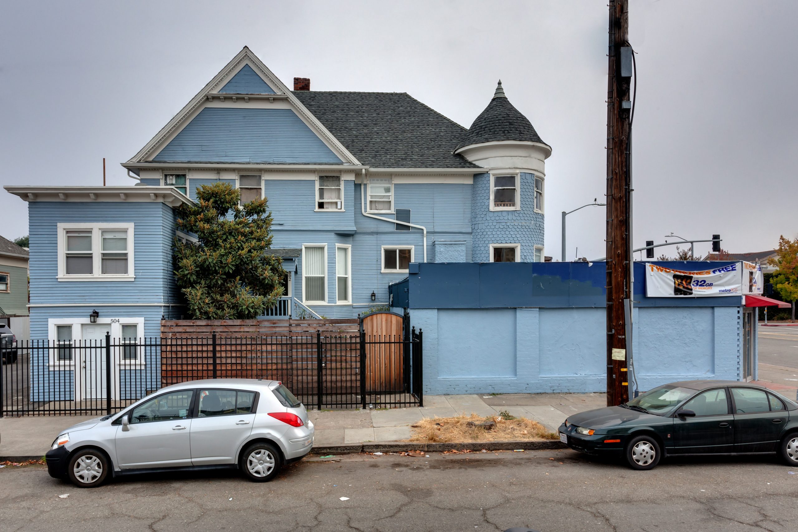 Blue-semi-Victorian-apartments-with-black-fence