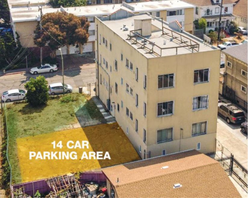 3 story cream building with 14 car parking area